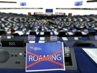 A paper with the word "Roaming", crossed out, is seen on the desk of a Member of the European Parliament during a debate in Strasbourg, March 11, 2015.            REUTERS/Vincent Kessler